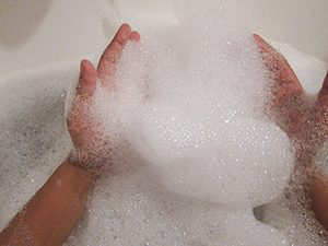 hands in bubble bath