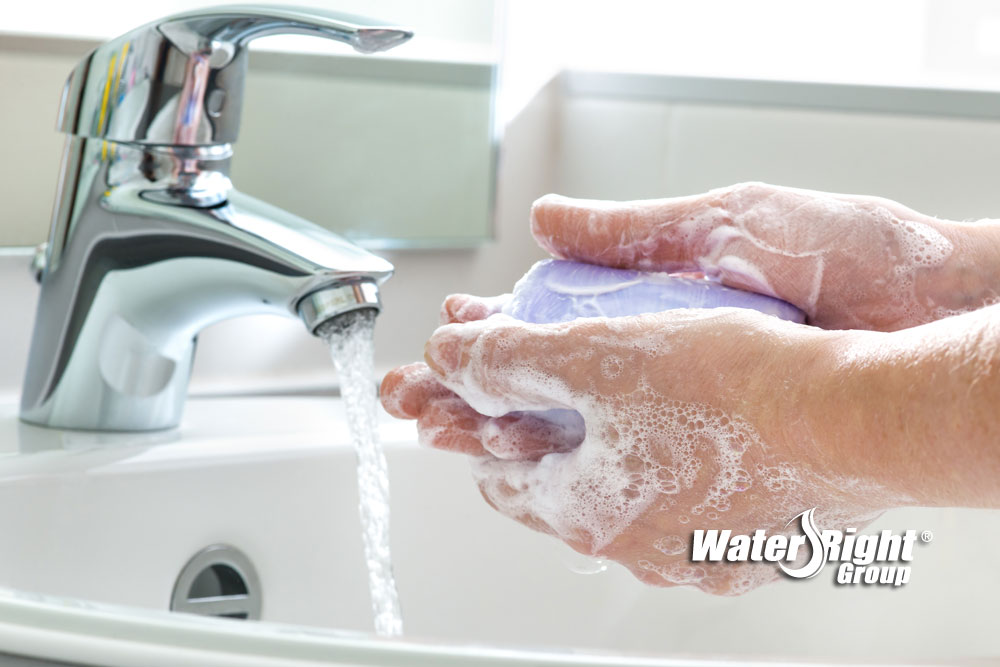 woman washing hands with hard water