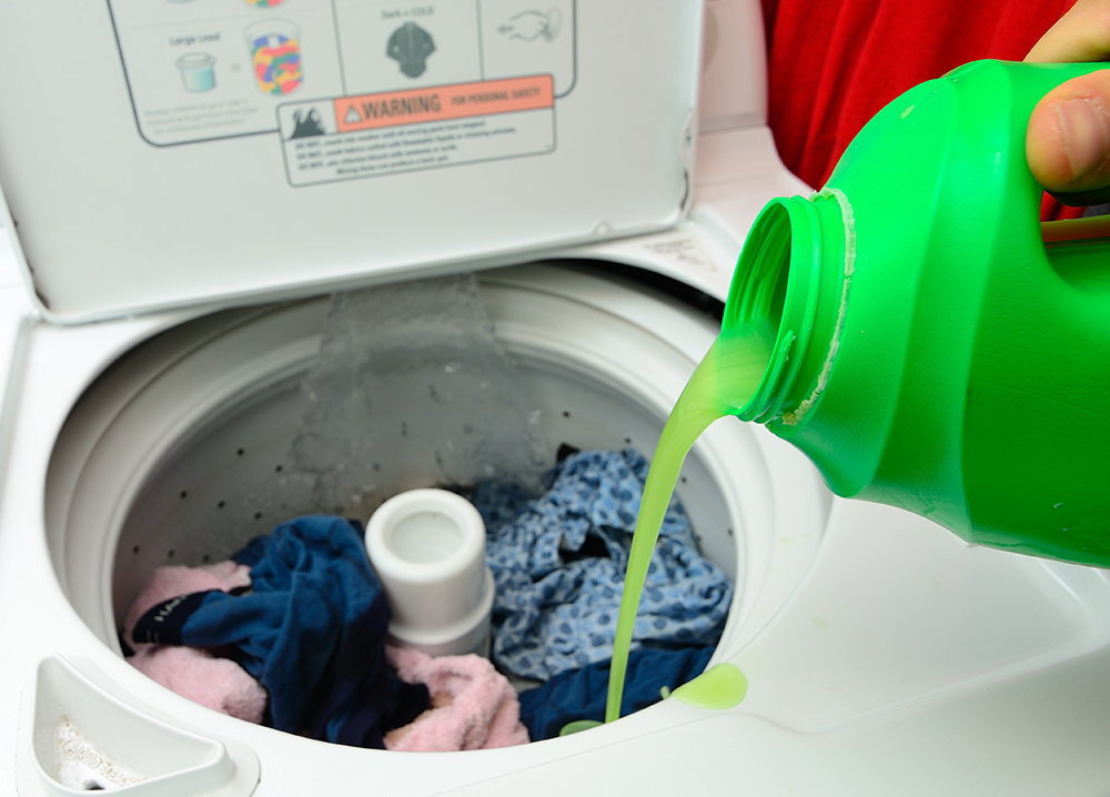 Pouring Detergent into the wash machine